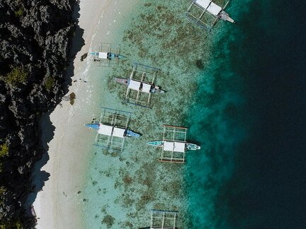 outriggers mooring on a tropical beach