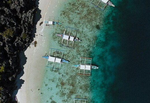 outriggers mooring on a tropical beach